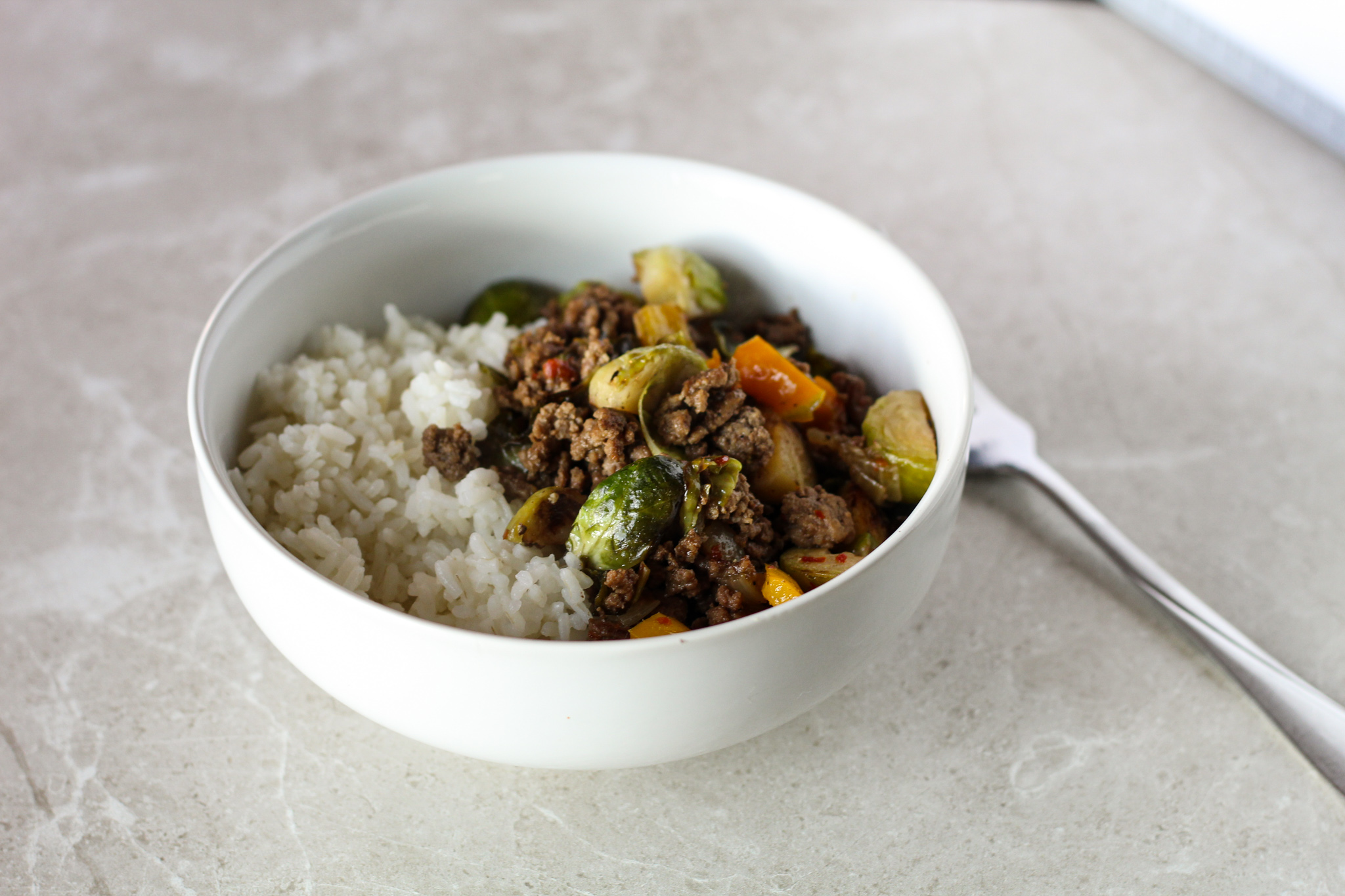 ground beef and brussels sprout stir fry in pan