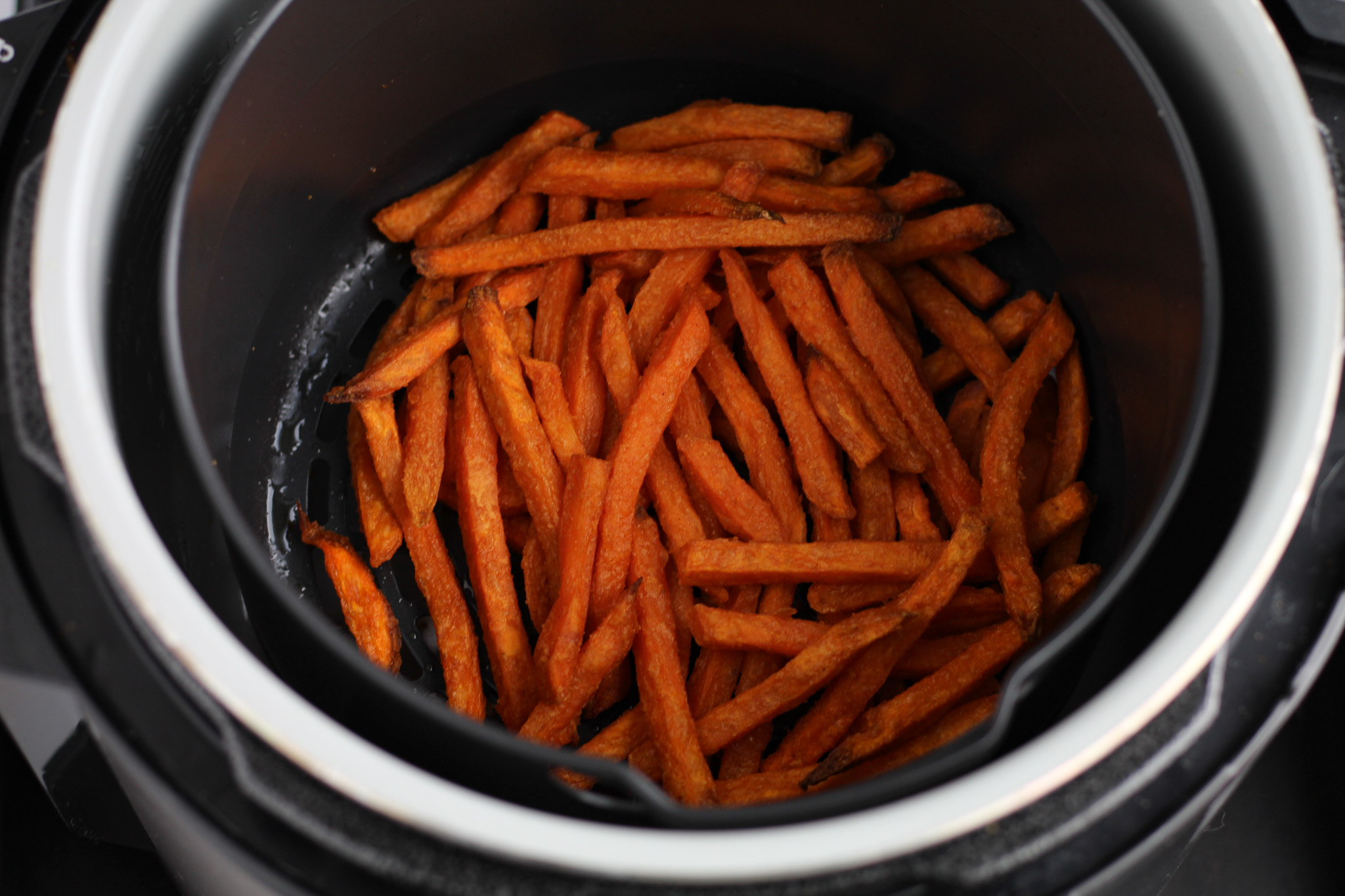 alexia frozen sweet potato fries cooking in an air fryer