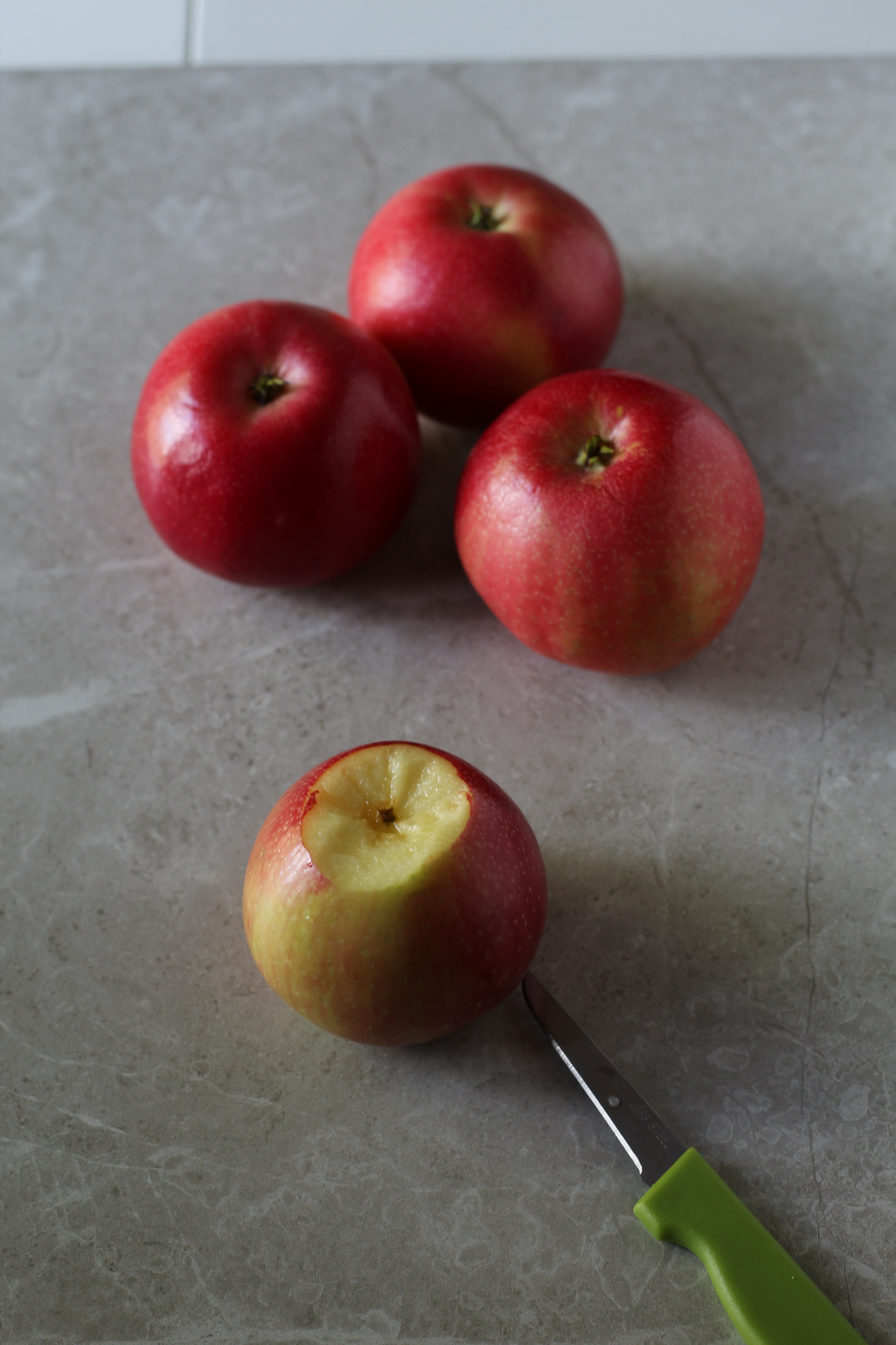 Apples sitting on a cutting board